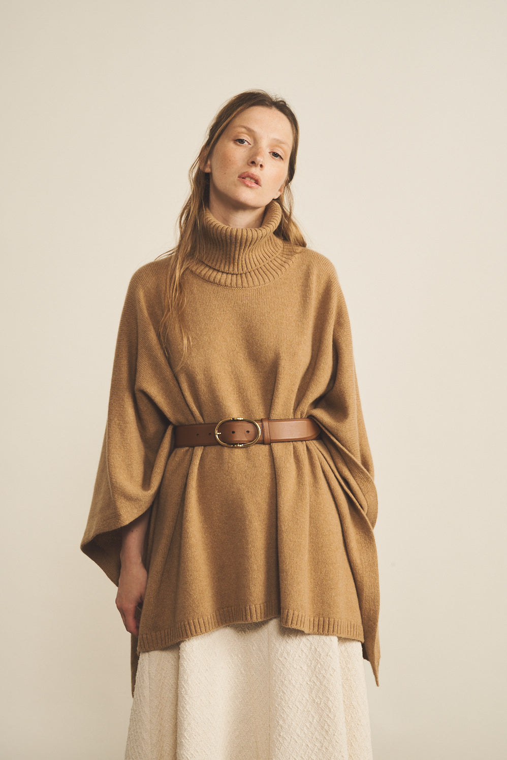 A camel, turtleneck women cashmere poncho with cut sides - face view | Angela | Linnea Lund