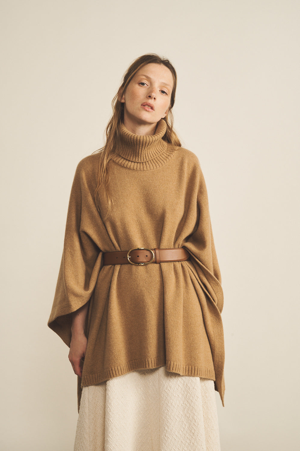 A camel, turtleneck women cashmere poncho with cut sides - face view | Angela | Linnea Lund