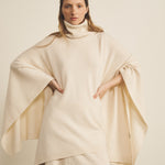 A white, turtleneck women cashmere poncho with cut sides - face view | Angela | Linnea Lund