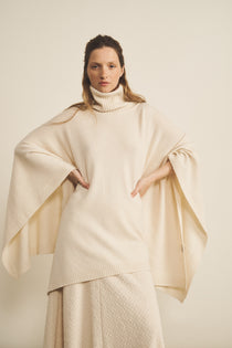 A white, turtleneck women cashmere poncho with cut sides - face view | Angela | Linnea Lund