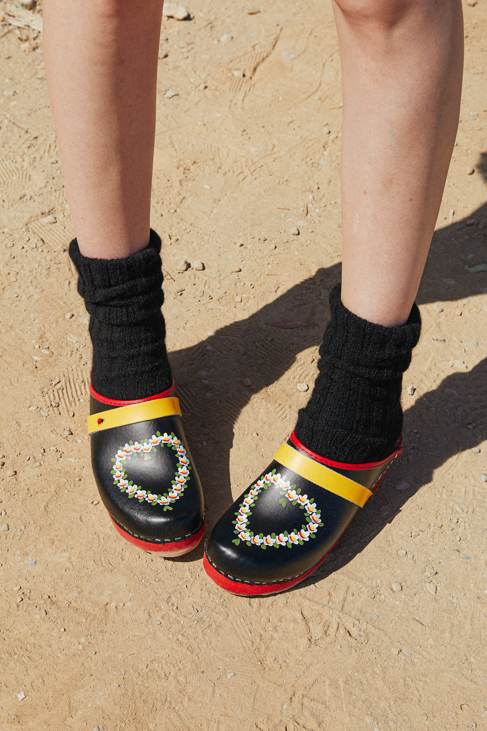 Swedish clogs worn with black cashmere socks.